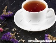 خرید و قیمت یک فنجان چای با گل های خشک روی میز سیاه. عکس رایگان | ترب