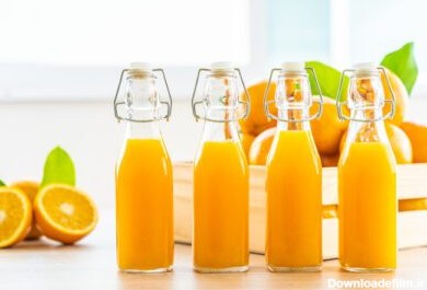 دانلود عکس آب پرتقال تازه برای نوشیدنی در شیشه بطری