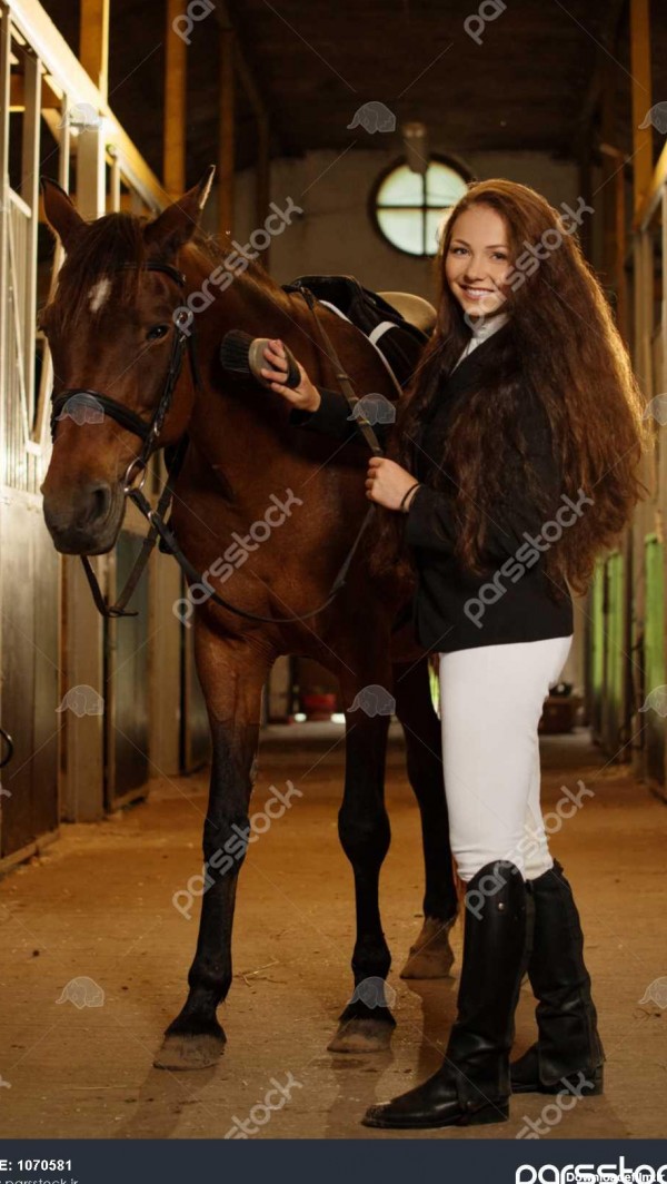 دختر زیبا با اسب خود را در یک غرفه 1070581