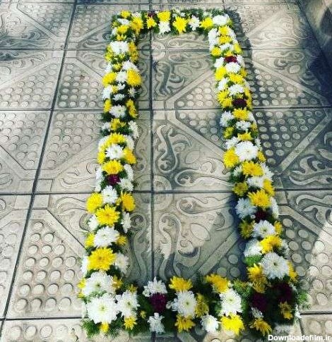 عکس تزیین گل روی سنگ قبر