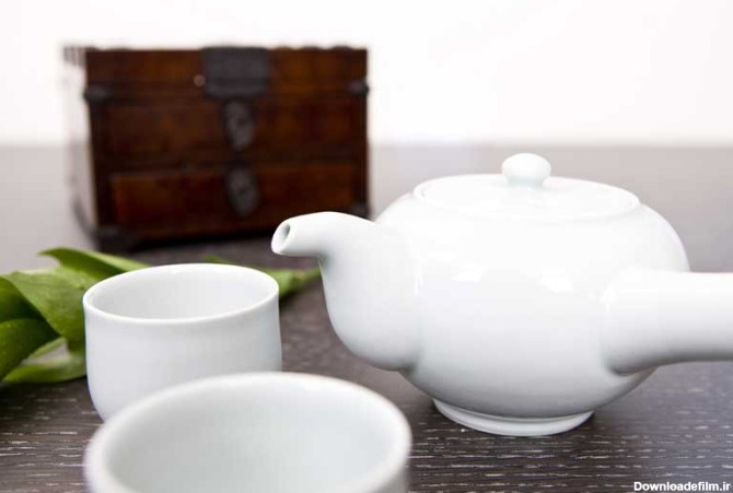 دانلود عکس زیبا از فنجان چای ، قوری و گل