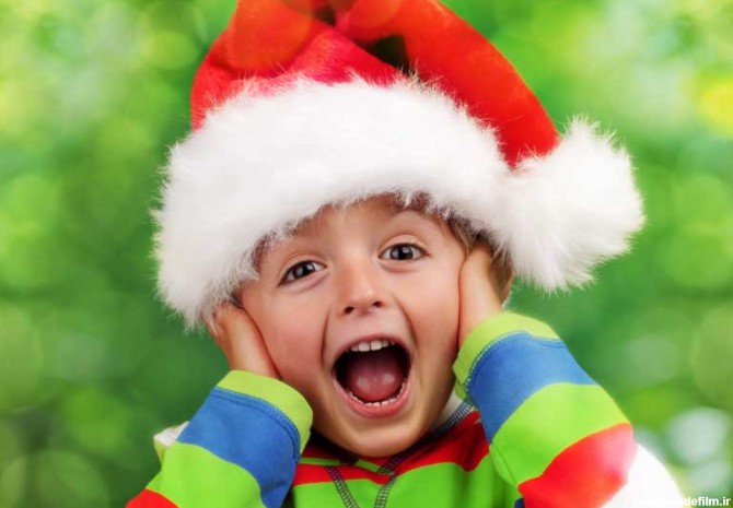 دانلود تصویر با کیفیت چهره پسر بچه خوشحال و هیجان زده با کلاه کریسمس