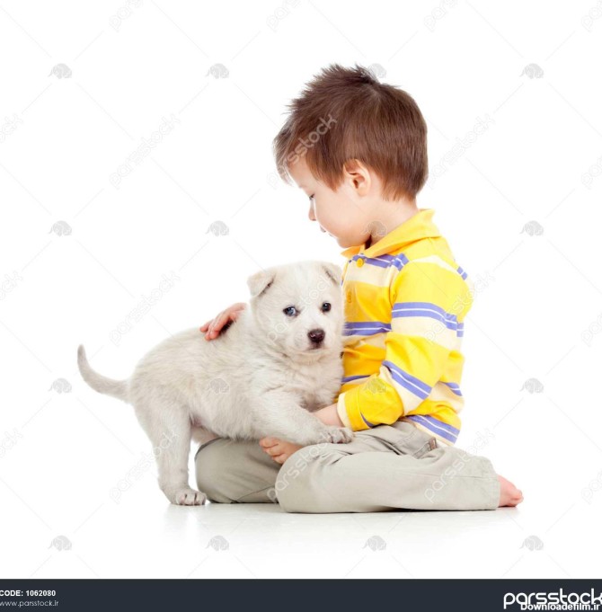 بچه ای که توله سگ را در پس زمینه سفید در آغوش می گیرد 1062080